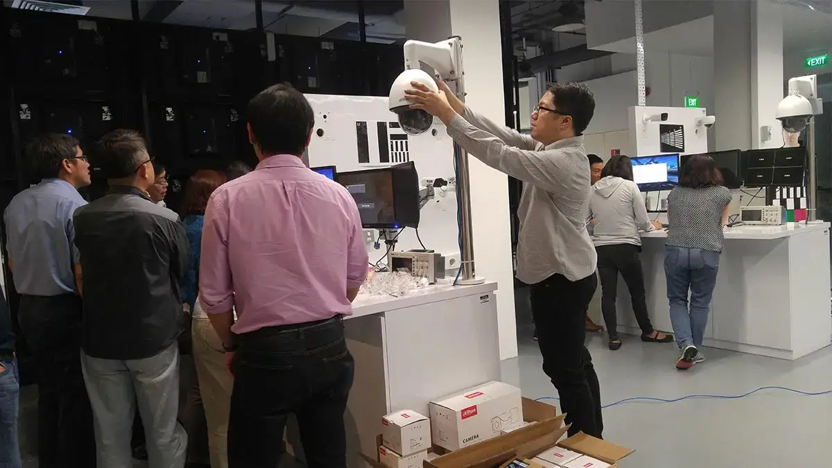 A technical instructor demonstrating PTZ camera installation to a group of students during a CCTV training course in the Philippines